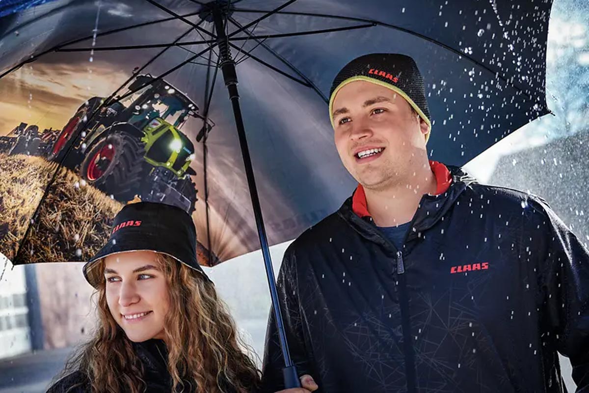 CLAAS Western team member smiling under an umbrella