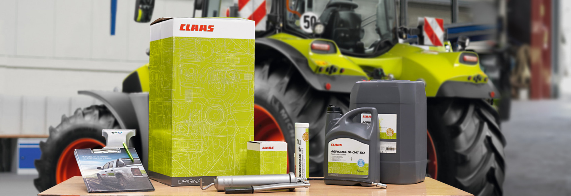 CLAAS genuine service parts box in front of a CLAAS tractor